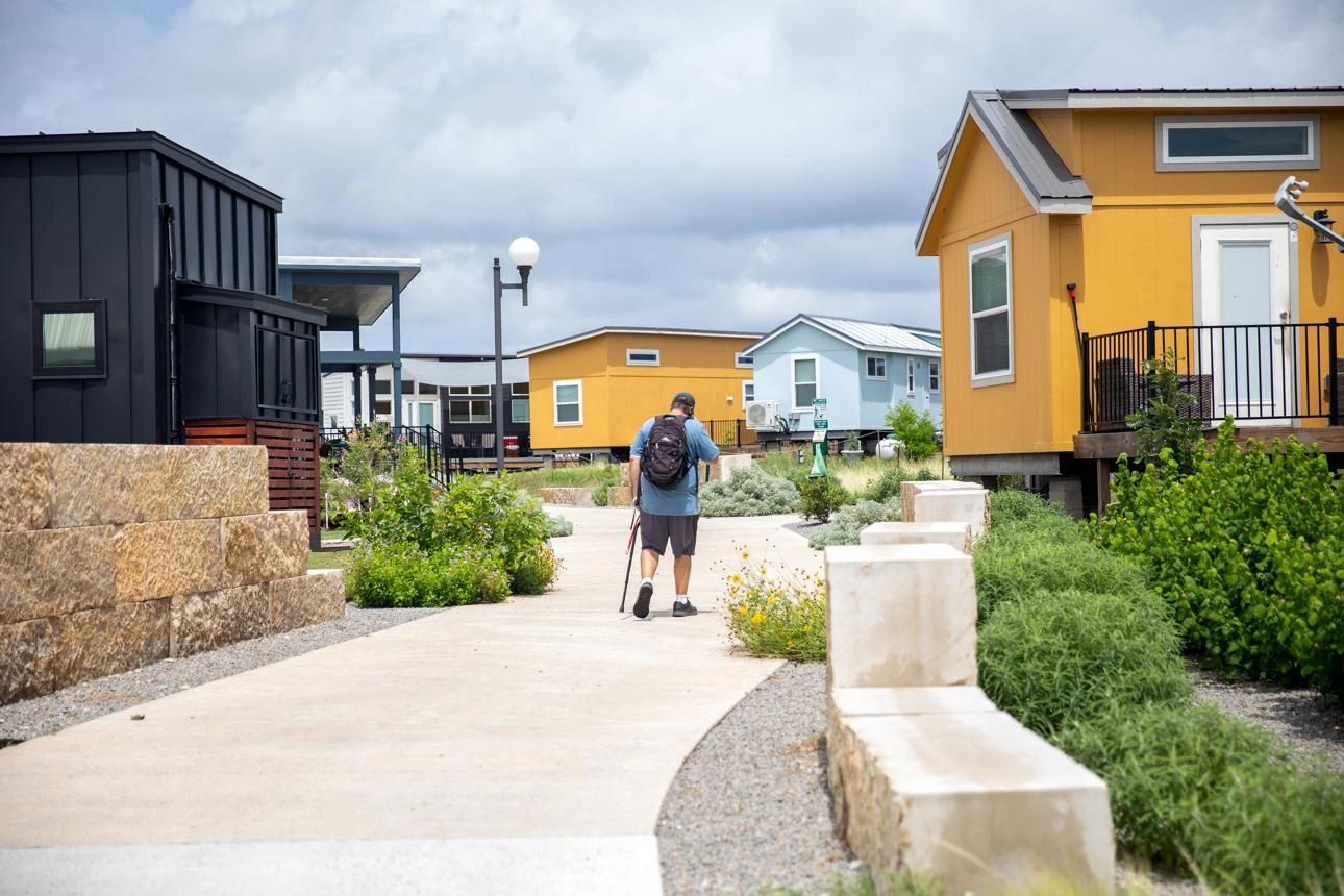 Community pathway lined with modern tiny homes