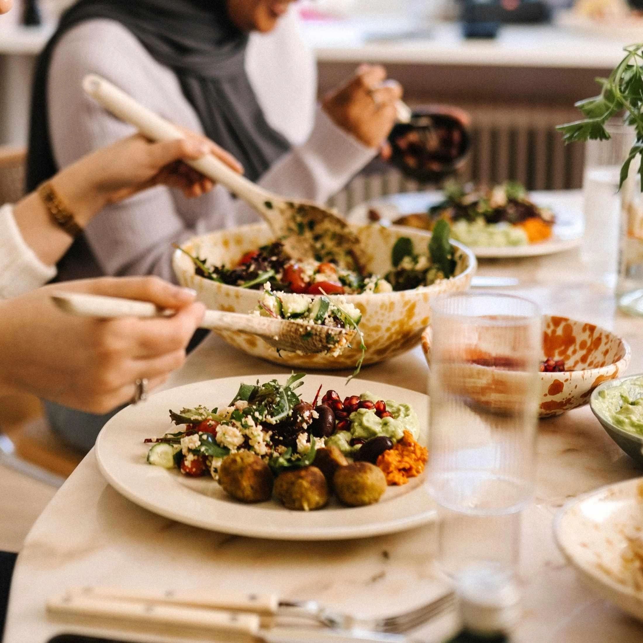 People sharing a colorful vegetable meal